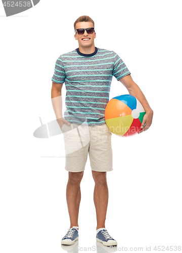 Image of smiling young man in sunglasses with beach ball