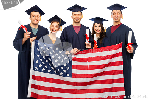 Image of graduate students with diplomas and american flag