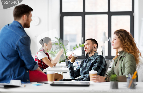 Image of creative team drinking coffee at office
