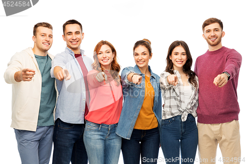 Image of group of smiling friends pointing at you over