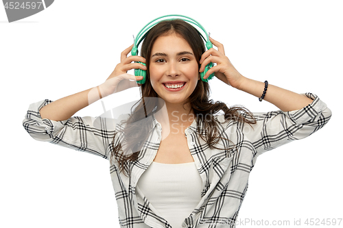 Image of happy young woman or teenage girl with headphones