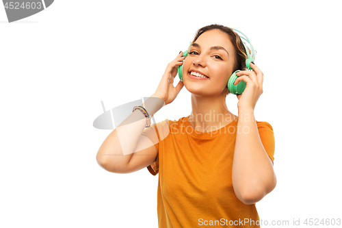 Image of happy young woman or teenage girl with headphones