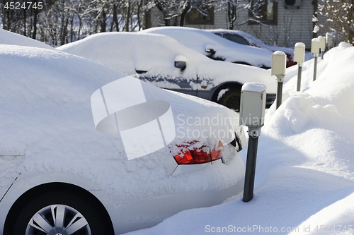 Image of cars covered in snow in the parking