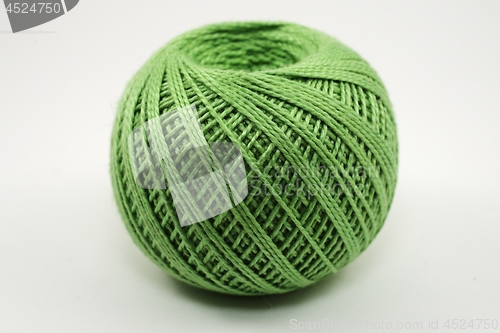 Image of a skein of green wool on a white 