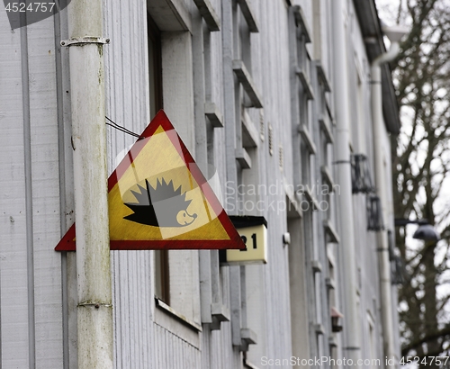 Image of traffic sign attention hedgehog on a house in Helsinki