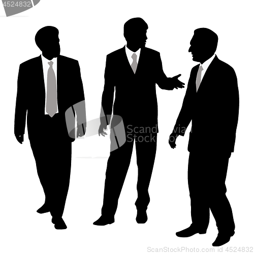 Image of Group of three businessmen walking and talking