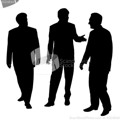 Image of Group of three businessmen walking and talking