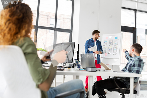 Image of creative man showing user interface at office