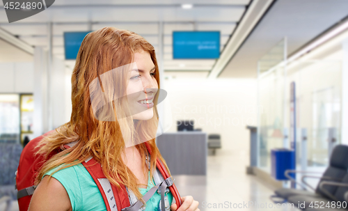 Image of young woman with backpack over airport terminal