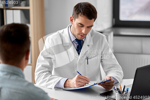 Image of doctor with clipboard and male patient at hospital