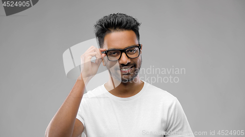 Image of happy indian man in eyeglasses or student