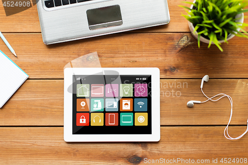 Image of close up of tablet pc computer on wooden table