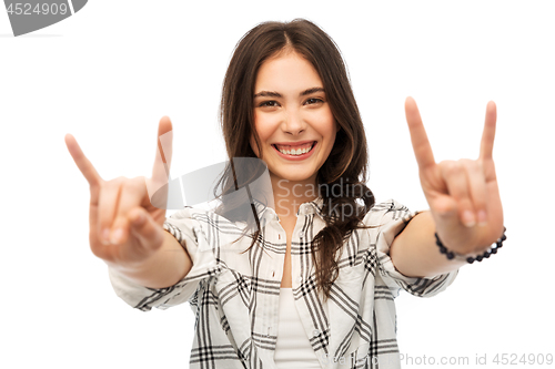 Image of young woman or teenage girl showing rock sign