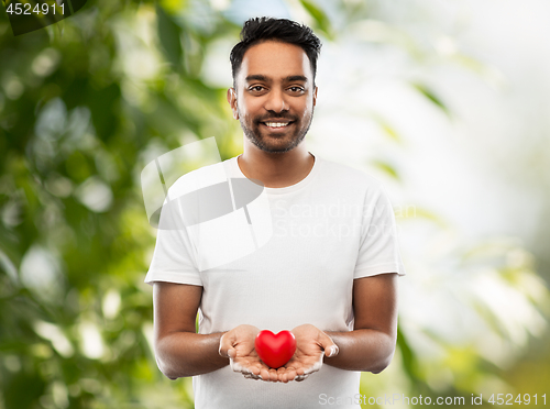 Image of smiling indian man with red heart