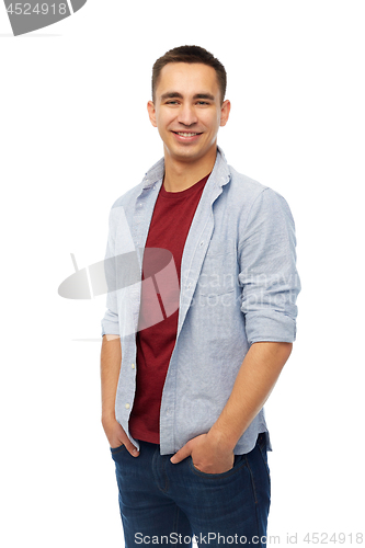 Image of smiling young man holding hands in pockets