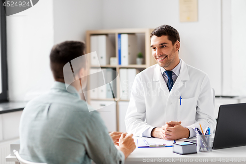 Image of doctor with laptop and male patient at hospital