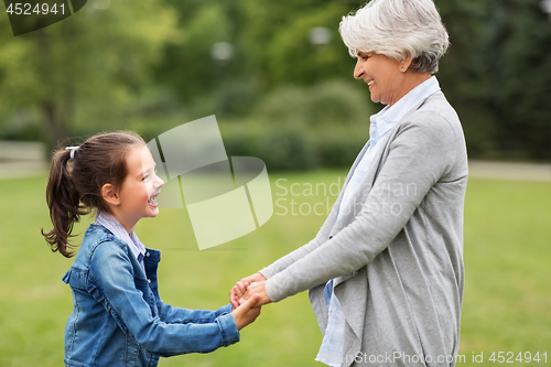 Image of grandmother and granddaughter playing at park