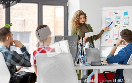 Image of creative woman showing user interface at office