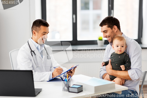 Image of father with baby and doctor at clinic