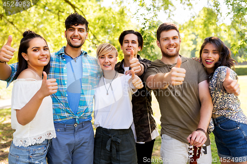 Image of friends with guitar showing thumbs up at park