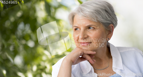 Image of portrait of senior woman over natural background