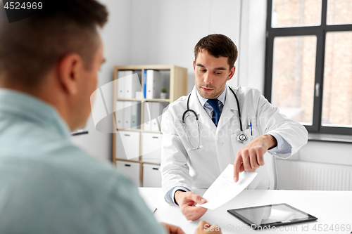 Image of doctor giving prescription to patient at hospital