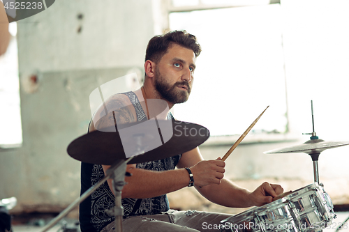 Image of Repetition of rock music band. drummer behind the drum set.