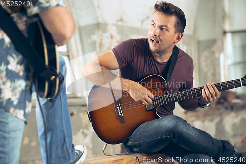 Image of Repetition of rock music band. Electric guitar player