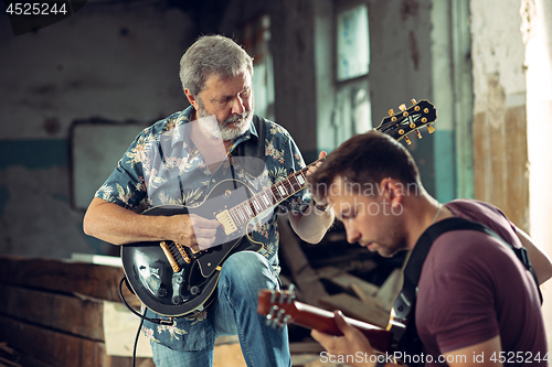 Image of Repetition of rock music band. Electric guitar players