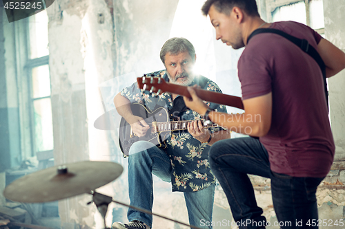 Image of Repetition of rock music band. Electric guitar players