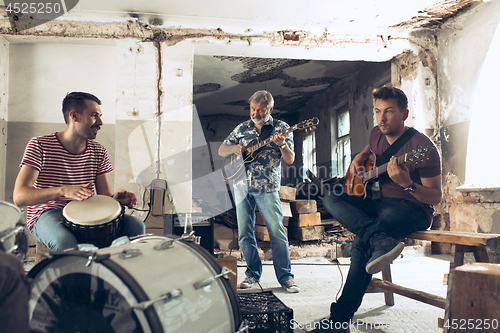 Image of Repetition of rock music band. Electric guitar player and drumme