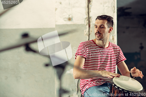 Image of Repetition of rock music band. drummer behind the drum set.