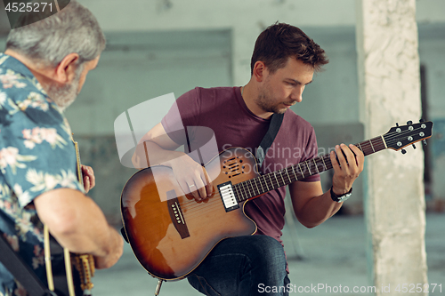 Image of Repetition of rock music band. Electric guitar players