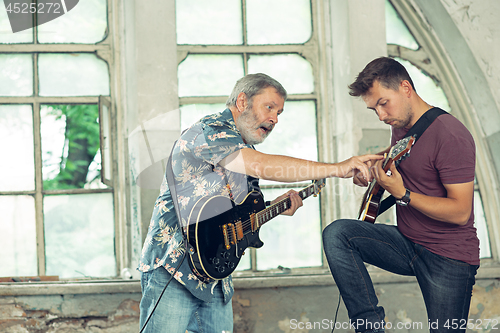 Image of Repetition of rock music band. Electric guitar players