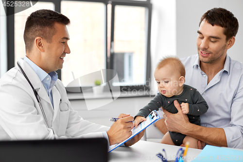 Image of father with baby and doctor at clinic