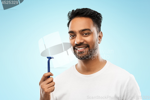 Image of indian man shaving beard with razor blade