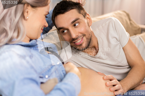 Image of happy man with pregnant woman at home