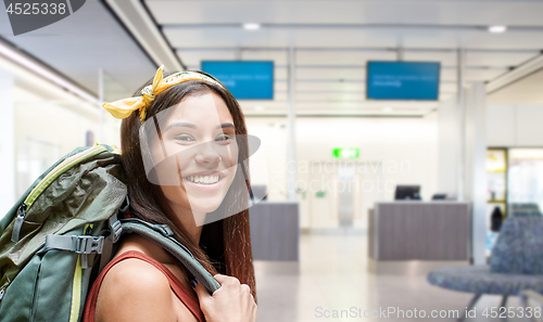 Image of young woman with backpack over airport terminal