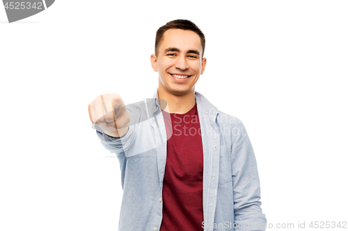Image of man pointing finger to you over white background