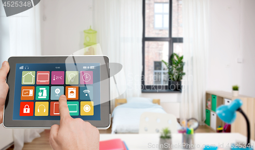 Image of hands with smart home icons on tablet computer