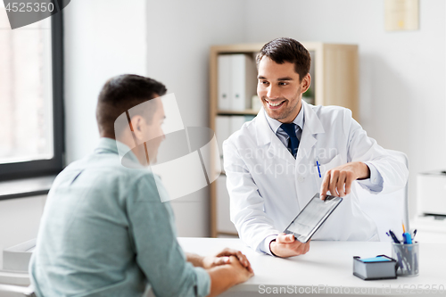 Image of doctor with tablet computer and patient at clinic