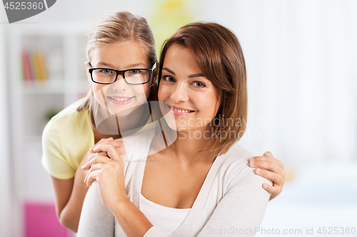 Image of portrait of happy mother and daughter at home