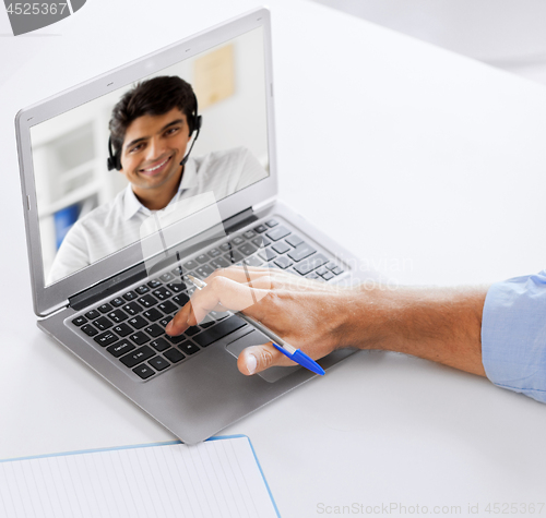 Image of businessman having video call on laptop at office