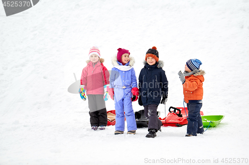 Image of happy little kids with sleds in winter