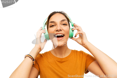 Image of happy young woman or teenage girl with headphones