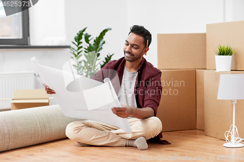 Image of man with boxes and blueprint moving to new home