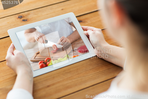 Image of woman watching cooking video on tablet computer