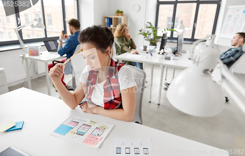 Image of creative woman working on user interface at office