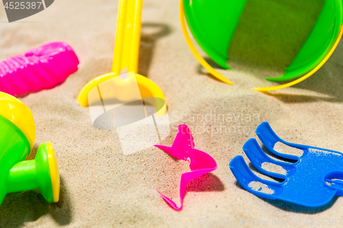 Image of close up of sand toys kit on summer beach