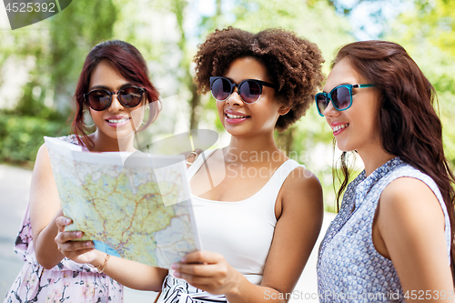 Image of happy women with map on street in summer city